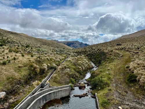 a bridge over a river in the middle of a desert at Spacious Rustic Villa - San Isidro, Carchi 