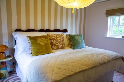 a bedroom with a bed with yellow and green pillows at Sandstone 34 in Chester