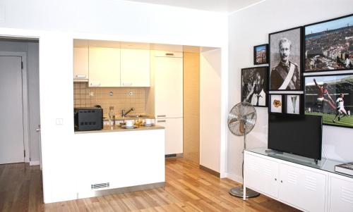 a living room with a television and a counter at Baixa Charming Apt. | Rosa 59 in Lisbon