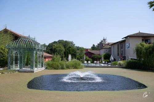 a fountain in a park with a gazebo at Georges Blanc Parc & Spa in Vonnas