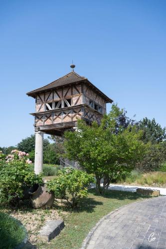 a wooden tower in a park with some trees at Georges Blanc Parc & Spa in Vonnas