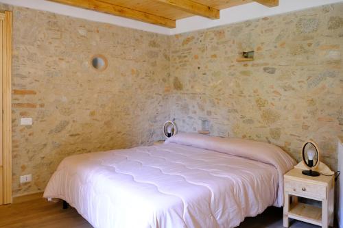 Ein Bett oder Betten in einem Zimmer der Unterkunft Ospitalità diffusa Jungi Mundu