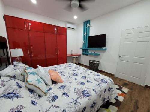 a bedroom with a bed and a red closet at Lakefront Paradise Retreat, Private Pool Vacation Home in Rivas, between Ometepe, Tola and San Juan del Sur in San Jorge