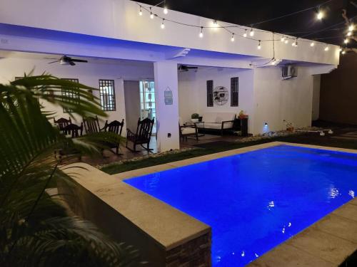 a house with a blue swimming pool at night at Lakefront Paradise Retreat, Private Pool Vacation Home in Rivas, between Ometepe, Tola and San Juan del Sur in San Jorge