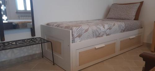 a small bed in a room with a mirror at Al Vicoletto Varese in Gazzada