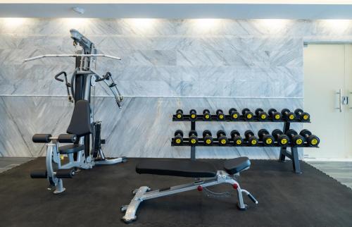 a gym with a treadmill and a bike at Sunday Jeddah Hotel in Jeddah