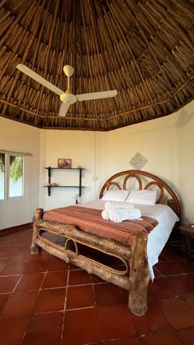 a bedroom with a wooden bed with a ceiling at Punta Manzanillo in San Bernardo del Viento