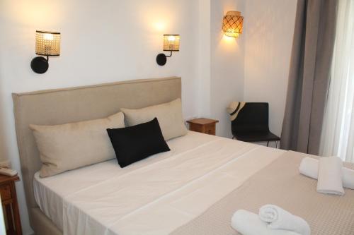 a bedroom with a bed with two towels on it at Rena's Guesthouse, by Comfortbnb in Sitia