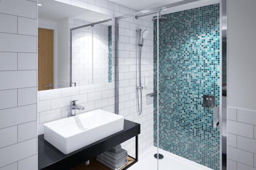 a bathroom with a sink and a glass shower at Holiday Inn Istanbul - Beylikduzu by IHG in Istanbul