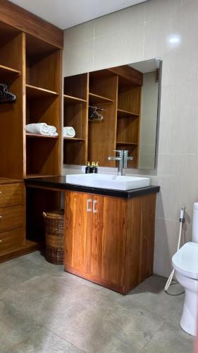 a bathroom with a sink and a toilet at Villa De Cupit Ubud Gianyar Bali in Ubud