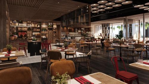 a rendering of a restaurant with tables and chairs at voco Bangkok Surawong by IHG in Bangkok