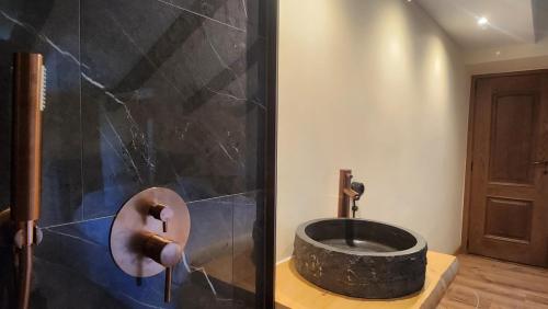 a bathroom with a shower with a stone tub at Villa Fonte in Ferrere