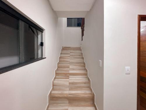 a staircase in a house with white walls and wooden floors at Casa Green Boa Vista in Barreirinhas