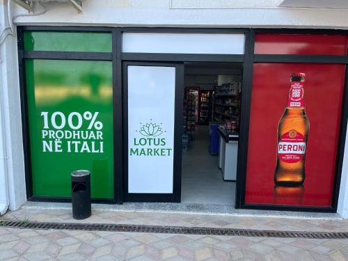 a store window with a bottle of beer in it at Lotus Apartments in Vlorë