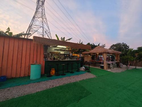 a bar on a green lawn next to a building at 復古車露營住宿 in Hong Kong