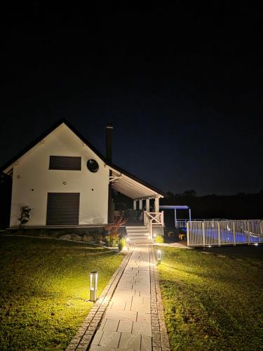 a house at night with a walkway in front at Moje srećno mesto in Arandjelovac