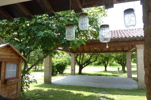 a wooden pergola withason jars hanging from it at Silea Apartments, Pool, Garden, Treviso in Silea