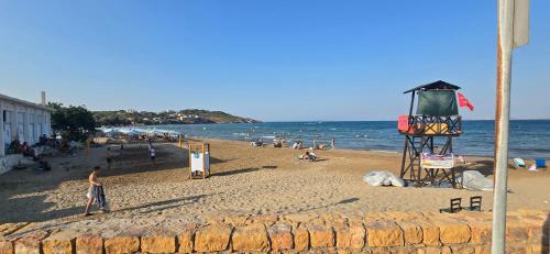 a group of people on a beach near the ocean at GLIPTIS Apartments in Karfas