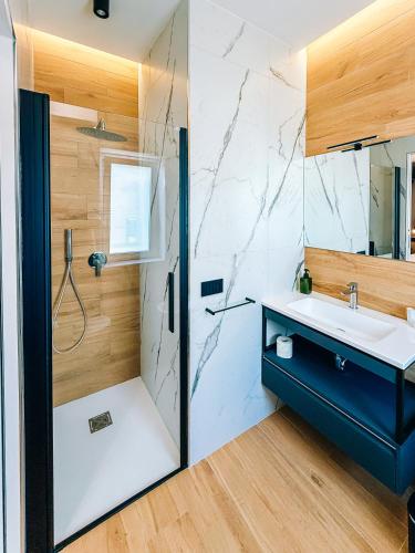 a bathroom with a sink and a shower at LumiaRooms B&B in Milazzo