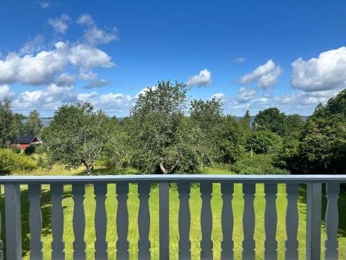 a white fence with trees in the background at Villa Calcar in Södertälje