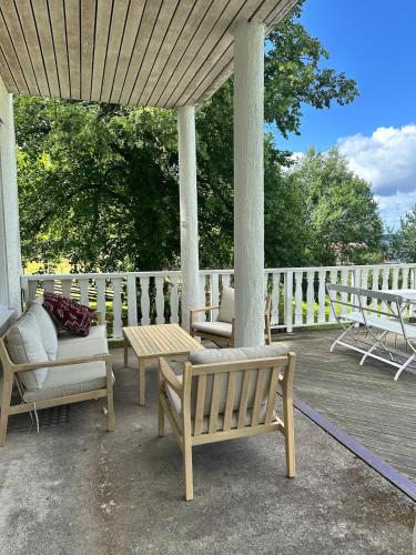 a porch with benches and a table and chairs at Villa Calcar in Södertälje