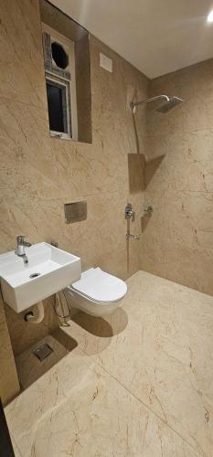 a bathroom with a sink and a toilet at Hotel Vaishno Bliss in Bhubaneshwar