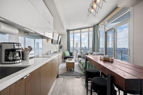 a kitchen and living room with a view of the city at High Floor 1 Bedroom Condo Iceboat Terrace Downtown Toronto in Toronto