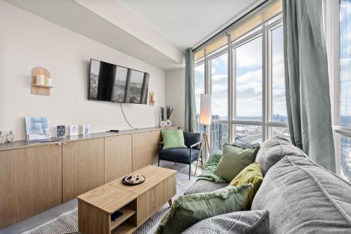 a living room with a couch and a table at High Floor 1 Bedroom Condo Iceboat Terrace Downtown Toronto in Toronto