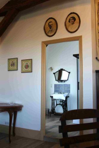 a doorway into a room with a table and a mirror at L'ancien Tribunal in Tonnerre