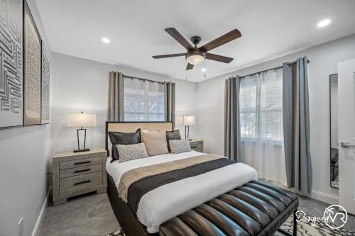 a bedroom with a bed and a ceiling fan at Luxury Retreat: Pool Games Basketball More in Largo