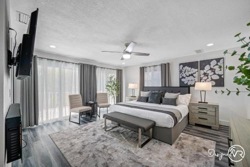 a bedroom with a bed and a television in it at Luxury Retreat: Pool Games Basketball More in Largo