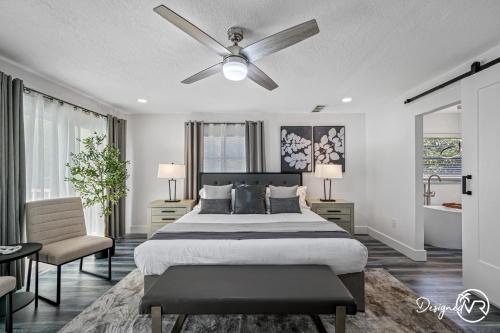 a bedroom with a bed and a ceiling fan at Luxury Retreat: Pool Games Basketball More in Largo
