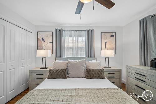 a white bedroom with a bed with two lamps at Luxury Retreat: Pool Games Basketball More in Largo