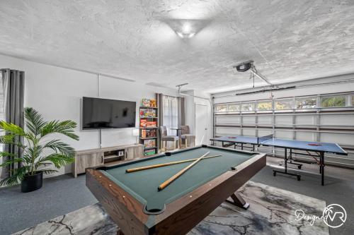 a room with two pool tables and a flat screen tv at Luxury Retreat: Pool Games Basketball More in Largo