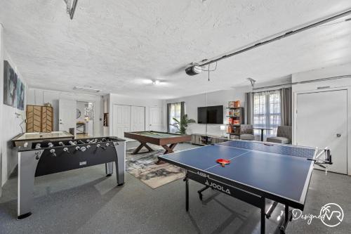 a living room with two ping pong tables in it at Luxury Retreat: Pool Games Basketball More in Largo