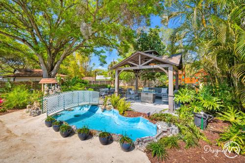 a swimming pool in a yard with a gazebo at Luxury Retreat: Pool Games Basketball More in Largo