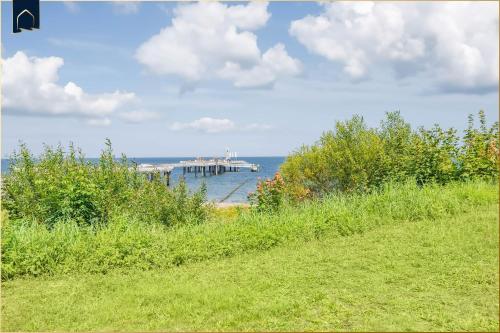 a dock with a large boat in the water at Seeblick Leuchtturm in Ostseebad Koserow