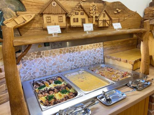 a buffet of food on a counter in a store at Hotel Podlesí in Podlesí