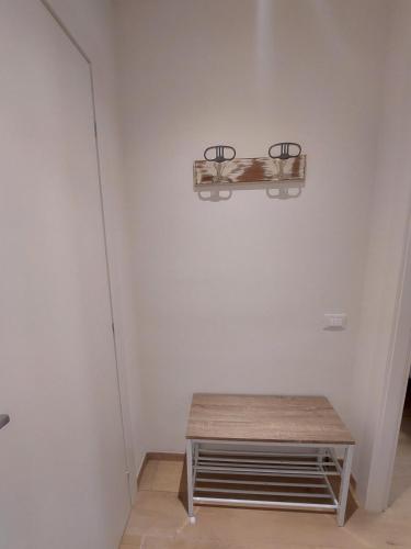 a room with a bench and a light on the wall at Camere Mediterranee in La Spezia