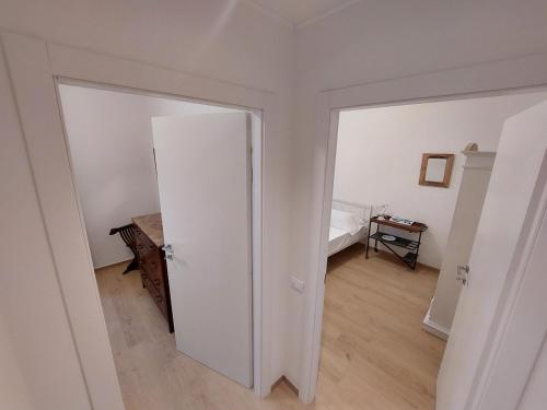 a room with an open door to a bedroom at Camere Mediterranee in La Spezia