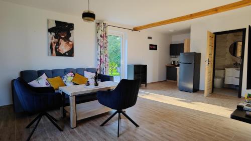 a living room with a couch and a table at Domki w Winnicy - Świętokrzyska Winnica Knapów in Krzczonowice
