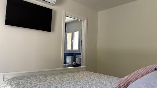 a bedroom with a bed and a large mirror at Hotel Antiga in Calafell