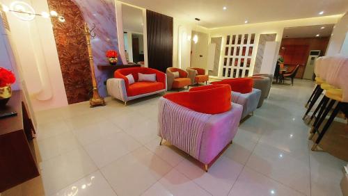 a lobby with couches and chairs in a room at The Ambassadors Hotel in Lagos
