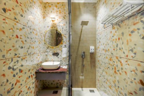 a bathroom with a sink and a shower at Elegance A Boutique Stay in Amritsar