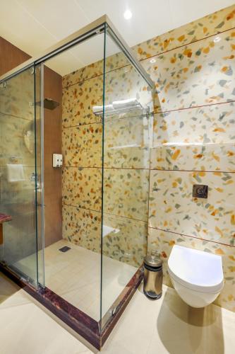 a shower stall in a bathroom with a toilet at Elegance A Boutique Stay in Amritsar