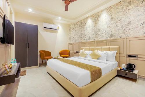 a hotel room with a bed and a tv at Elegance A Boutique Stay in Amritsar