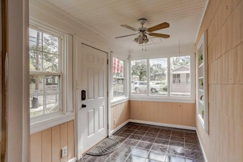 a home hallway with a ceiling fan and windows at Sunny Midtown Cottage- Midtown Mobile in Mobile
