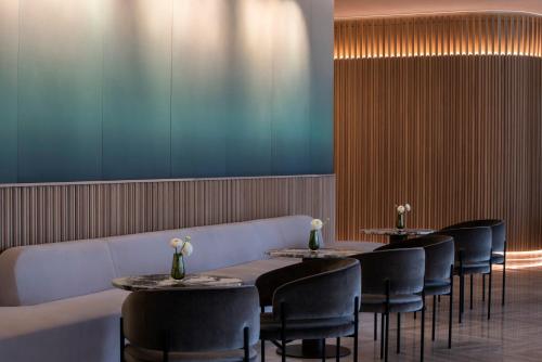 a row of tables and chairs in a restaurant at Four Seasons Hotel Montreal in Montréal