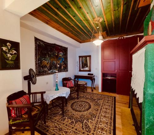 a living room with a table and chairs at Meliteion Traditional Hotel in Asprangeloi