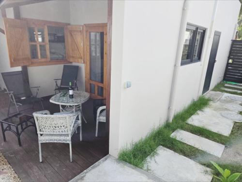 a view of a patio with a table and chairs at Villa Soleil D’été in Blue Bay